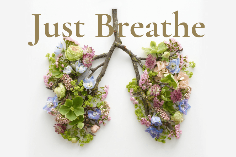 flowers arranged in the shape of lungs with the words, just breathe