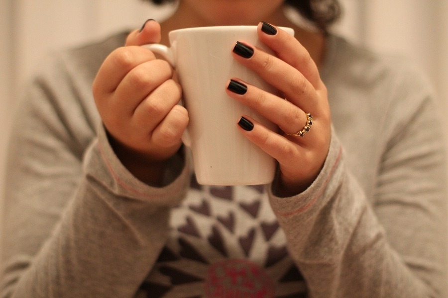 woman taking time to slow down and drink tea to relax