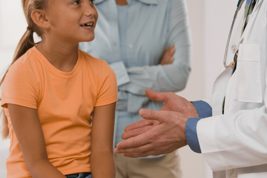 early onset puberty mother and daughter talking with pediatrician