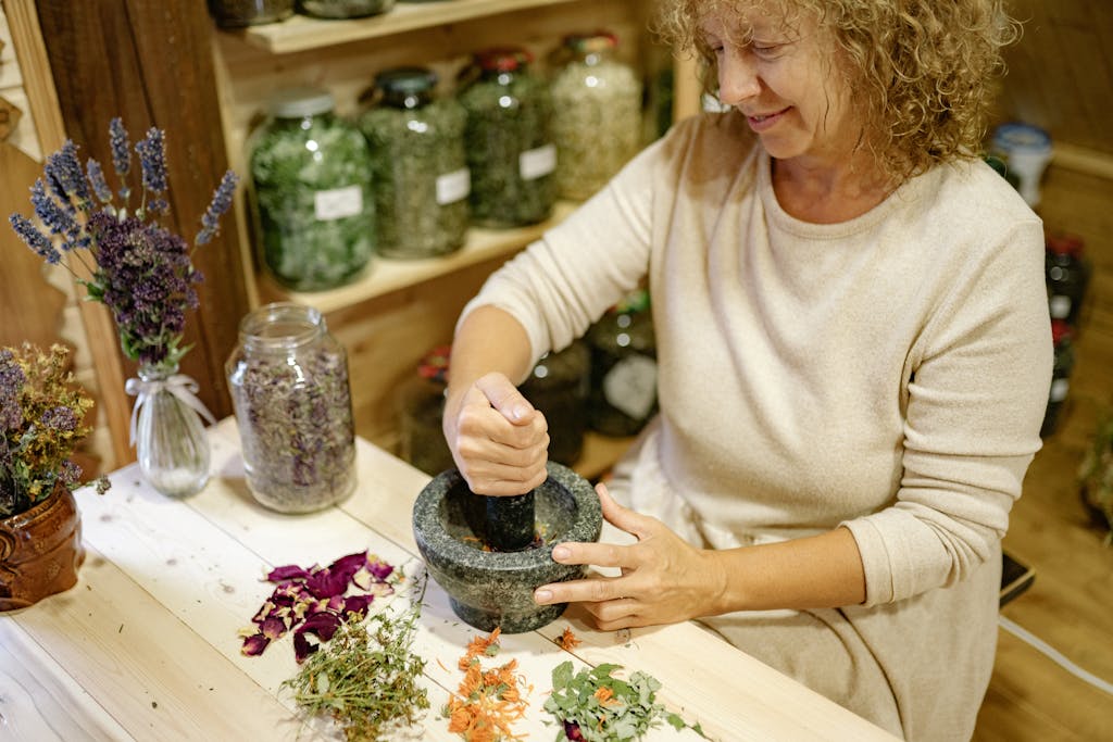 essential medicinal herbs being pounded in mortar